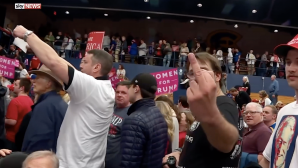 Trump supporter gives journalist the middle finger at a campaign rally in 2020. Courtesy of Media Education Foundation.